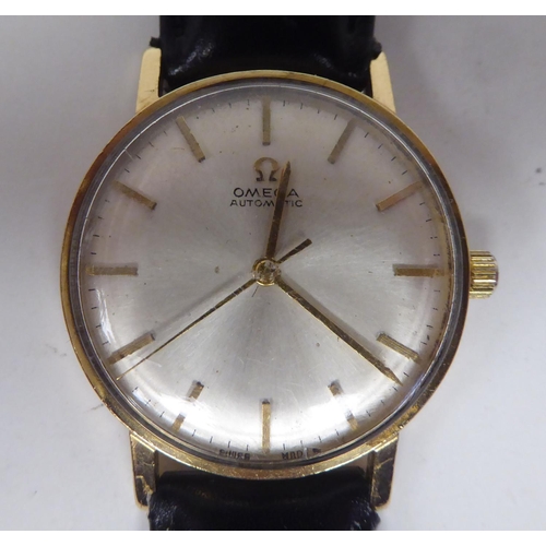 100 - An Omega 9ct gold cased wristwatch, the automatic movement faced by a baton dial, on a black hide st... 