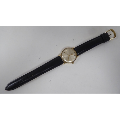 100 - An Omega 9ct gold cased wristwatch, the automatic movement faced by a baton dial, on a black hide st... 