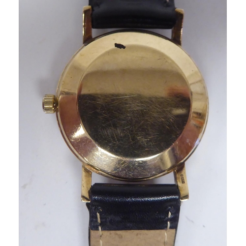 100 - An Omega 9ct gold cased wristwatch, the automatic movement faced by a baton dial, on a black hide st... 