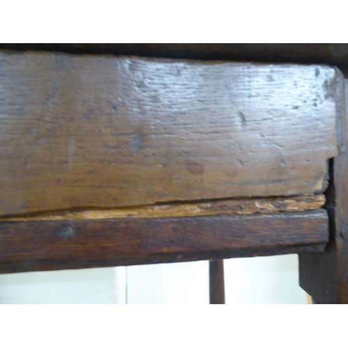 107 - A George III oak single drawer side table, raised on turned and block legs  25