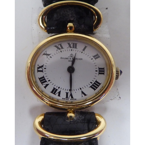 109 - A lady's Baume & Mercia 18ct gold oval cased wristwatch, on a black hide strap