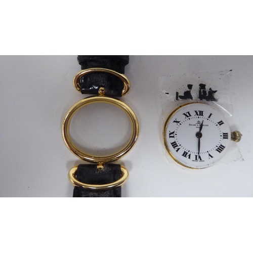 109 - A lady's Baume & Mercia 18ct gold oval cased wristwatch, on a black hide strap