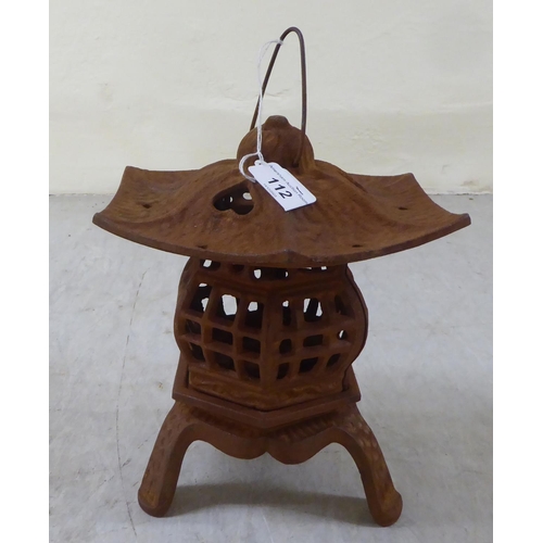 112 - A rust coloured cast iron, pagoda design tealight holder  8