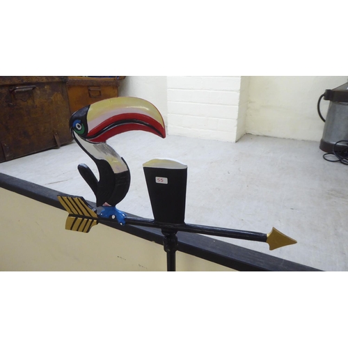 130 - A modern painted, cast iron weather vane, surmounted by a Guinness Toucan