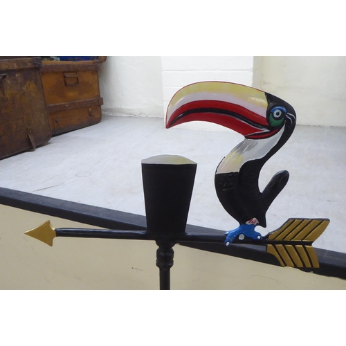 130 - A modern painted, cast iron weather vane, surmounted by a Guinness Toucan