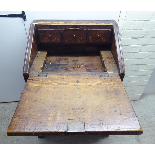 142 - A 19thC painted pine bureau with a hinged lid, over three graduated drawers, raised on bracket feet&... 