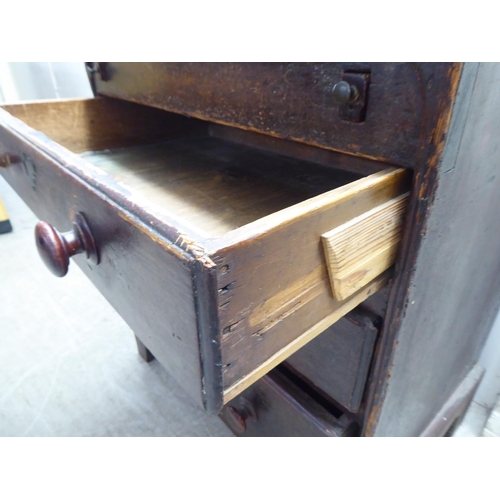 142 - A 19thC painted pine bureau with a hinged lid, over three graduated drawers, raised on bracket feet&... 