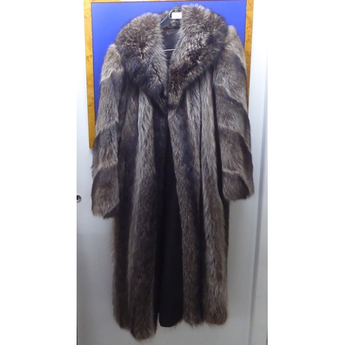 152 - A three-quarter length fur coat with a silk lining  approx. size 12/14