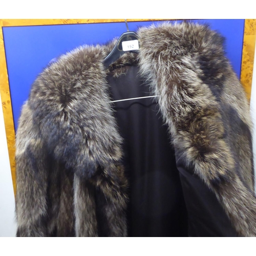 152 - A three-quarter length fur coat with a silk lining  approx. size 12/14