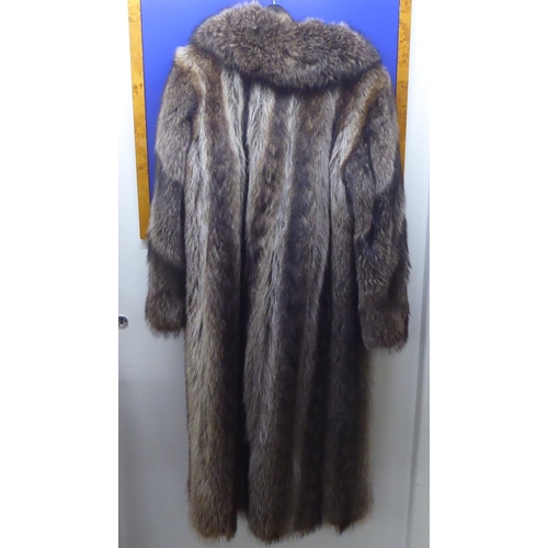 152 - A three-quarter length fur coat with a silk lining  approx. size 12/14