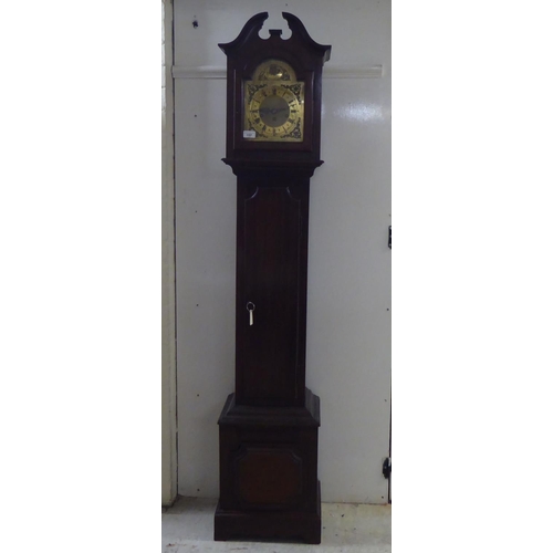 157 - A modern mahogany cased granddaughter clock; the movement faced by a Roman dial  69