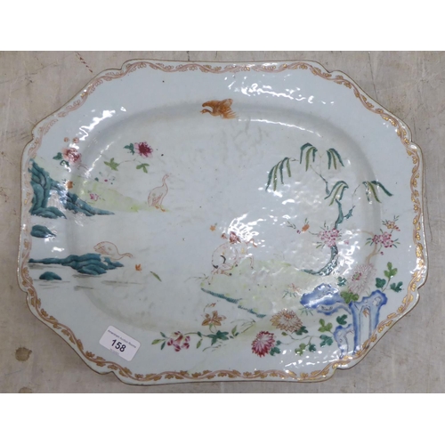 158 - An 18thC Chinese porcelain meat plate, decorated with a landscape  17