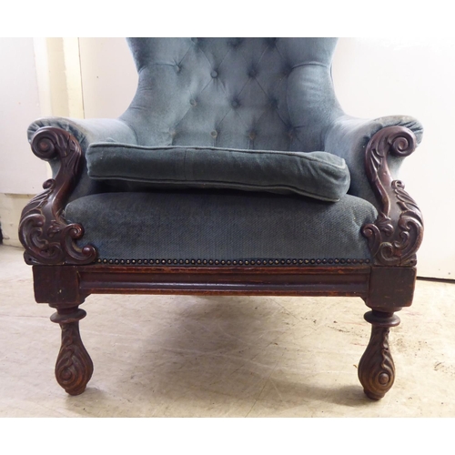 162 - A mid Victorian mahogany showwood framed salon chair, later part button upholstered in blue fabric, ... 