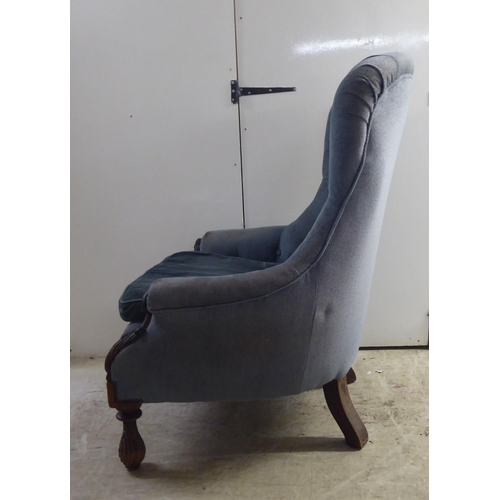 162 - A mid Victorian mahogany showwood framed salon chair, later part button upholstered in blue fabric, ... 