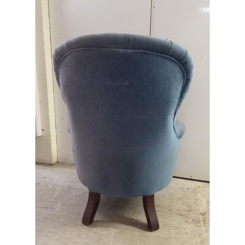 162 - A mid Victorian mahogany showwood framed salon chair, later part button upholstered in blue fabric, ... 