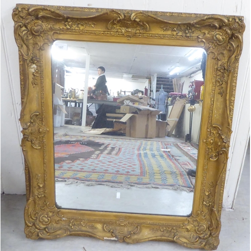 187 - A 20thC mirror, the plate set in a moulded gilt frame  28