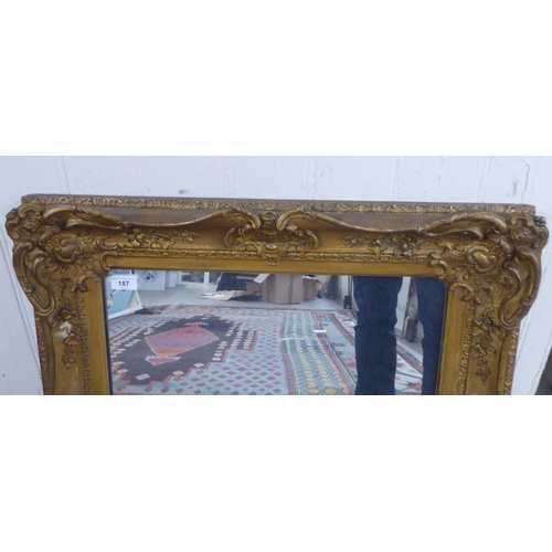 187 - A 20thC mirror, the plate set in a moulded gilt frame  28