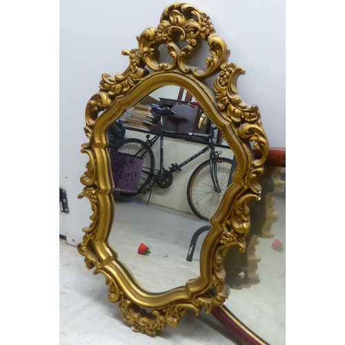 198 - Mirrors: to include a mid 20thC Japanese inspired red painted and gilt framed example  19