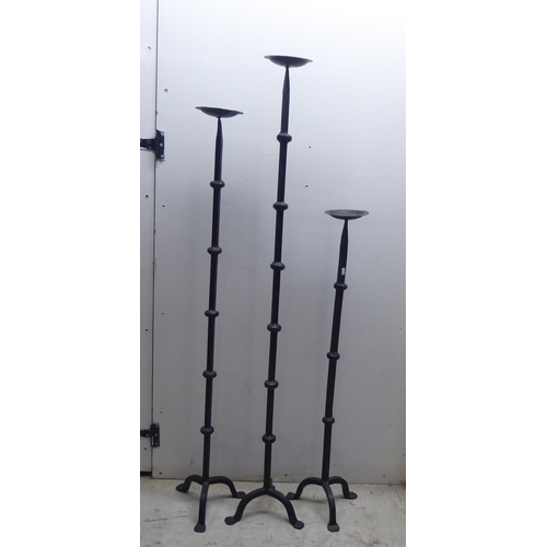 203 - 20thC metalware: to include Old English style cast iron pricket candlesticks  largest 50