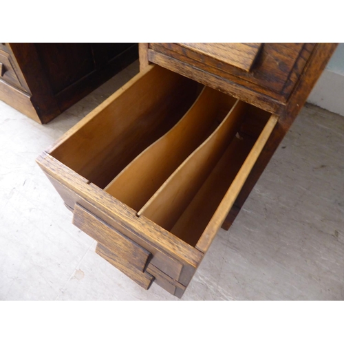 208 - A 1930s oak veneered one piece, nine drawer twin pedestal desk, on a plinth  30