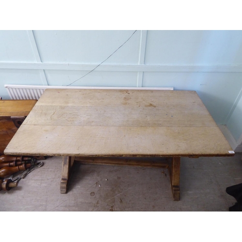 212 - A late 19thC oak refectory table, the planked top over a pair of crossover supports and platform fee... 