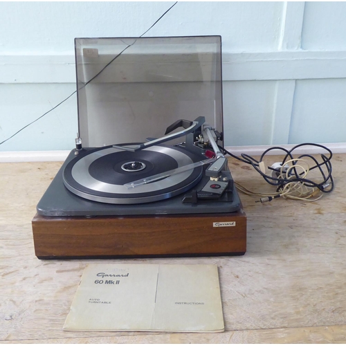 217 - A Garrard 60 MKII record deck, in a teak effect and tinted plastic hinged case  14