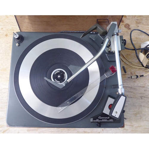 217 - A Garrard 60 MKII record deck, in a teak effect and tinted plastic hinged case  14