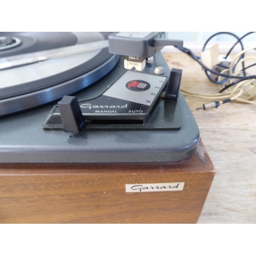 217 - A Garrard 60 MKII record deck, in a teak effect and tinted plastic hinged case  14