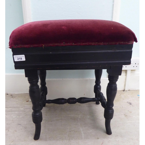 218 - An Edwardian black painted height adjustable music stool, raised on ring turned legs 