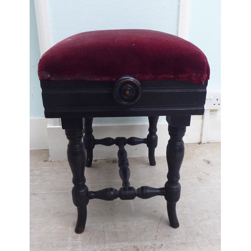 218 - An Edwardian black painted height adjustable music stool, raised on ring turned legs 