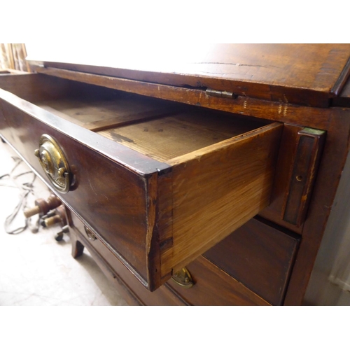 220 - A George III mahogany bureau with a fall flap, over four graduated drawers, raised on bracket feet&n... 