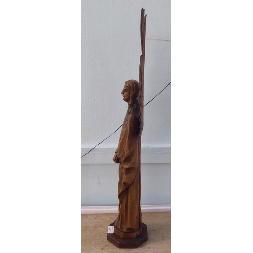 241 - A 20thC carved oak figure, a standing angel with outspread wings, on an octagonal plinth  29