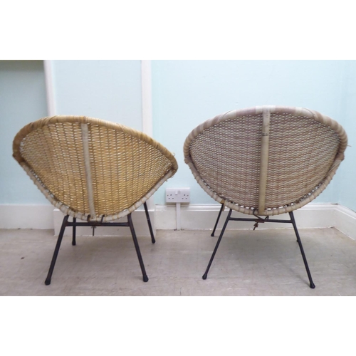 248 - A pair of vintage rubberised cane work effect chairs, raised on cast metal legs