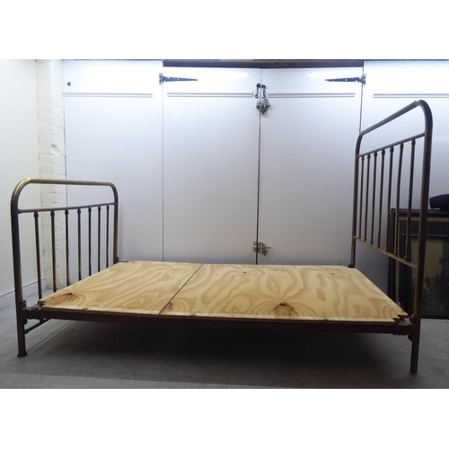 253 - An early 20thC lacquered brass single bed frames, the headboard 48