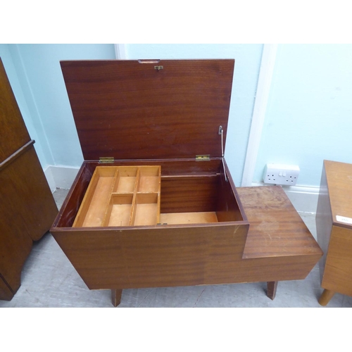 260 - A pair of 1970s teak tables of staggered form with hinged lids and drawer compartments  17