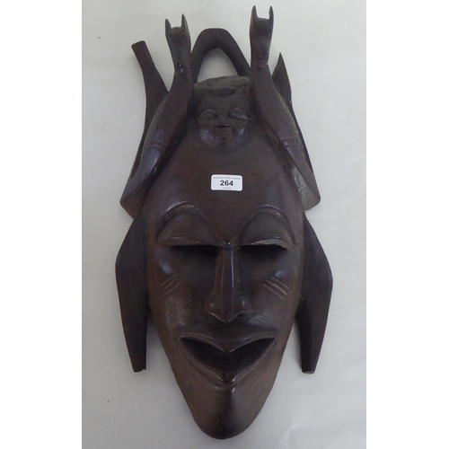 264 - 20thC carved artefacts: to include a mask  23