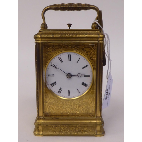 268 - An early 20thC (probably French) lacquered and ornately engraved brass and glazed carriage timepiece... 