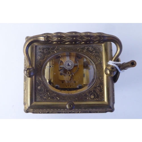 268 - An early 20thC (probably French) lacquered and ornately engraved brass and glazed carriage timepiece... 