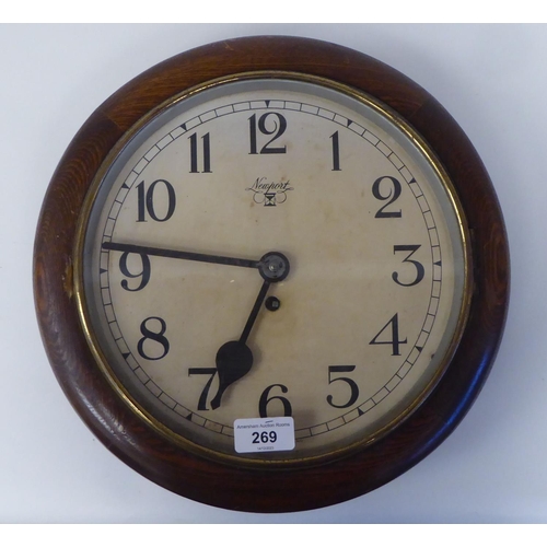 269 - A mid 20thC Newport oak cased timepiece; the movement faced by an Arabic dial  13