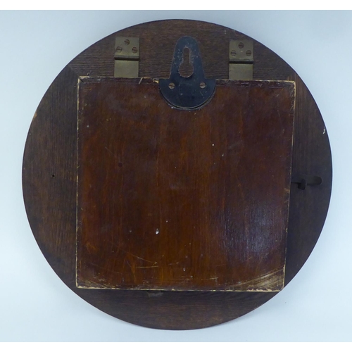 269 - A mid 20thC Newport oak cased timepiece; the movement faced by an Arabic dial  13