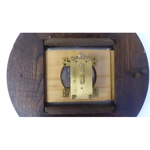 269 - A mid 20thC Newport oak cased timepiece; the movement faced by an Arabic dial  13