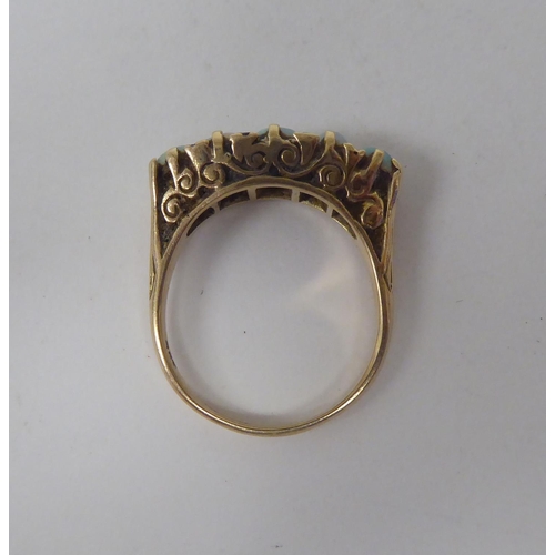 274 - A late Victorian yellow metal ring, set with five graduated opals  stamped 9ct 