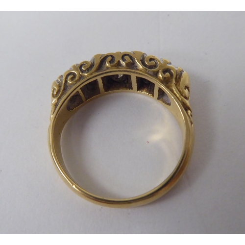 275 - A late Victorian yellow metal ring, set with five graduated diamonds  stamped 18ct 