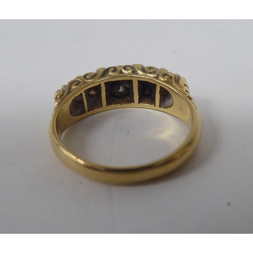 275 - A late Victorian yellow metal ring, set with five graduated diamonds  stamped 18ct 