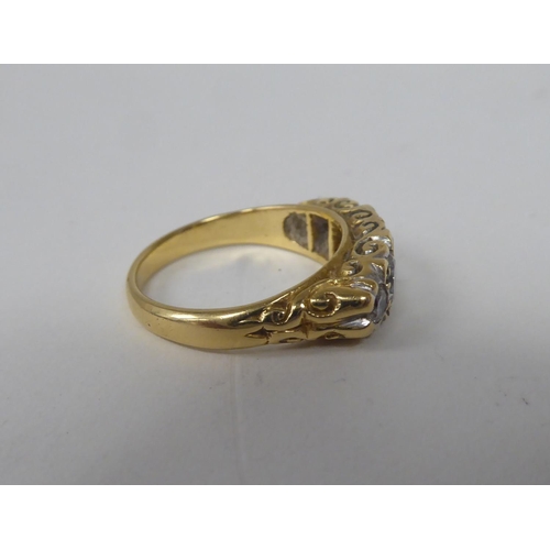 275 - A late Victorian yellow metal ring, set with five graduated diamonds  stamped 18ct 