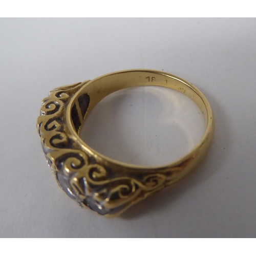 275 - A late Victorian yellow metal ring, set with five graduated diamonds  stamped 18ct 