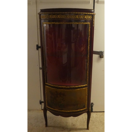 277 - A 20thC reproduction of an 18thC European inspired stained beech corner vitrine with gilt metal moun... 