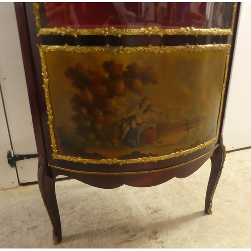 277 - A 20thC reproduction of an 18thC European inspired stained beech corner vitrine with gilt metal moun... 