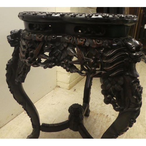 282 - A late 19th/early 20thC carved Chinese hardwood jardinière stand with a marble inset top, rai... 