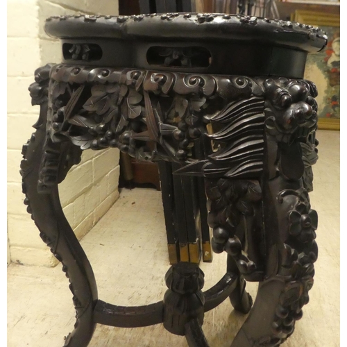 282 - A late 19th/early 20thC carved Chinese hardwood jardinière stand with a marble inset top, rai... 